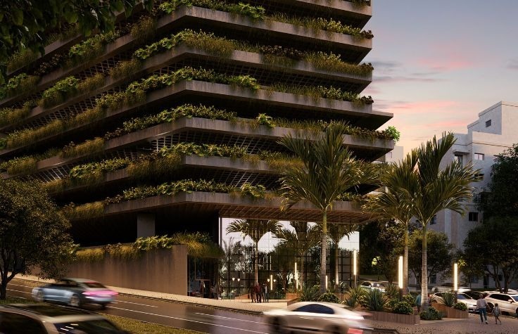 Prédio moderno com áreas verdes mostrando que investimento imobiliário vale a pena em projetos valorizados.